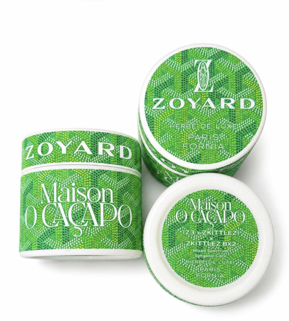 Three Green Zoyard jars by Maison O Caçapo in green Goyard-pattern packaging, showing Zoyard branding, Herbe de Luxe Paris-Fornia label, and (Z3 × Zkittlez) × Zkittlez BX2 genetics on the lid