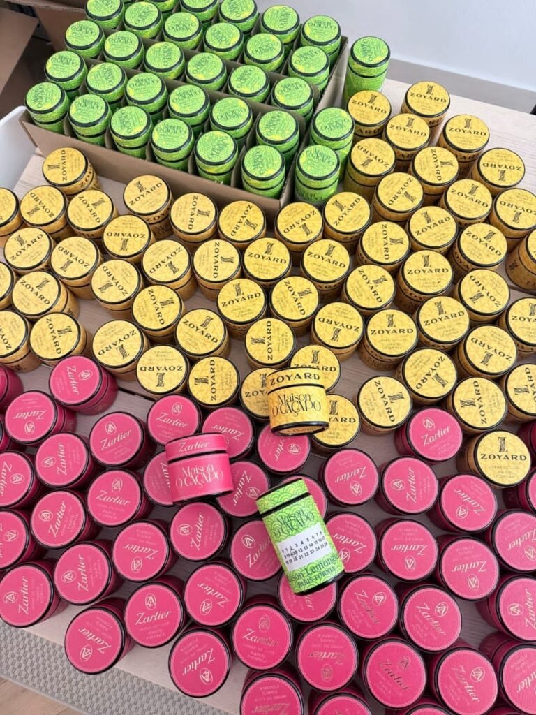 Arrangement of luxury Maison O Cacapo cannabis tins and jars featuring Zartier and Zoyard branding