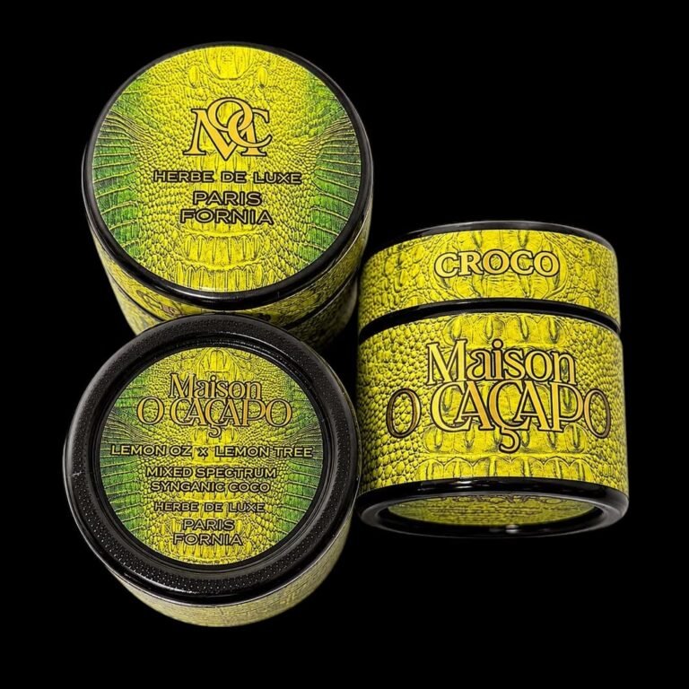 Trio of Maison O Caçapo black glass jars with yellow crocodile-skin pattern labels displaying Lemon OZ x Lemon Tree cultivar details on a black background.