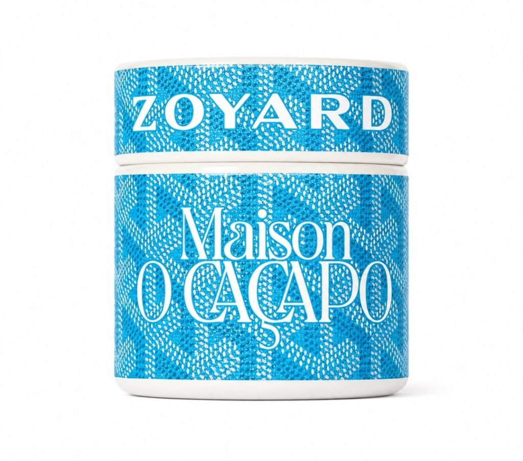 Maison O Caçapo Blue Zoyard luxury cannabis packaging featuring a striking blue and white geometric designer pattern, OZK x Zkittlez x Zkittlez BX2 lineage, and Herbe De Luxe Paris-Fornia branding.