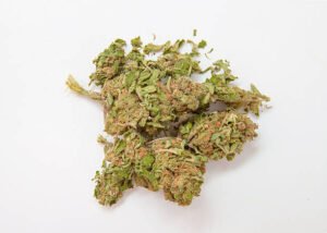 Dry cured cannabis nugs showing visible orange pistils and green calyxes isolated on a seamless white studio background.